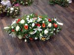 classic red, orange and cream Lilly coffin say  fresh  funeral flowers free delivery local and surrounding areas casket tribute funeral flowers roses coffin florist designer hand made traditional 